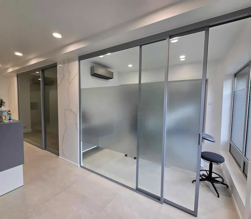 Cloisons vitrées coulissantes en métal avec verre dépoli, réalisation Metal Hanart pour local professionnel